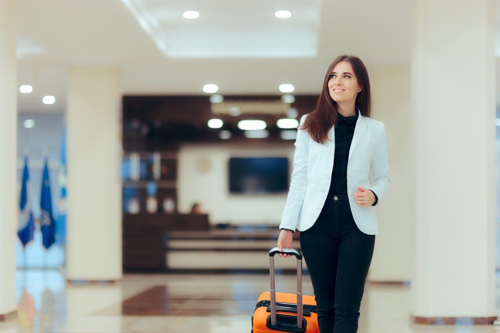 Woman walking with a luggage in the airport